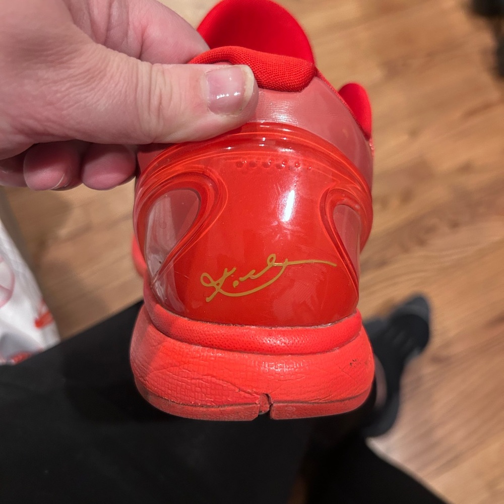 Nike Red Sneakers with Glossy Finish and Rounded Heel